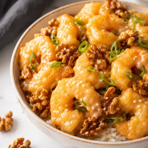 Chinese-style honey walnut shrimp served over jasmine rice with candied walnuts and green onions